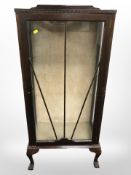 A 1920s mahogany glazed door display cabinet, 57cm x 32cm x 127cm.