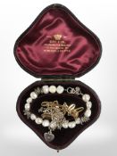 A silver mounted pearl bracelet, a gold plated bracelet and a child's silver necklace.