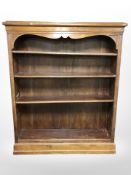 An early 20th century continental mahogany open bookcase with adjustable shelves,