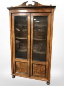 A 19th century continental burr walnut and ebonised double door glazed bookcase,