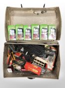 A vintage suitcase containing Subbuteo football teams, Tri-ang Hornby railway track, etc.