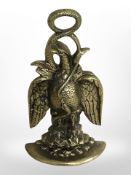 A cast-brass doorstop in the form of an eagle and serpent, height 34cm.