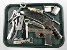 A kukri knife in sheath, a group of folding multi tools,