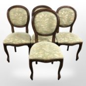 A set of four reproduction mahogany dining chairs in floral upholstery