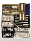 Several boxes of silver plate and stainless steel cutlery.