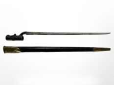 A British Pattern 1853 socket bayonet with brass-mounted WD stamped leather scabbard,
