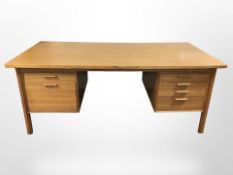 A 20th century Danish teak twin-pedestal writing desk,