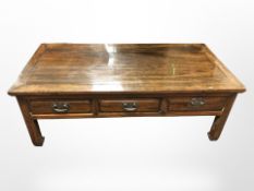 A 20th-century Chinese lacquered elm three-drawer low coffee table,