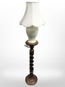 A barley twist torchère and a ceramic table lamp.