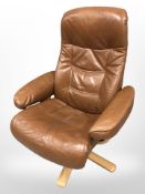 A late 20th century Danish stitched tan leather swivel armchair on bentwood support