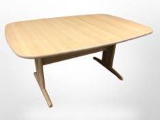 A contemporary Danish pine effect dining table,