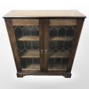 A New Plan Furniture glazed oak double door cabinet, 83cm x 30cm x 97cm.