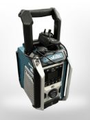 A Makita DMR115 bluetooth portable radio speaker, with charger.