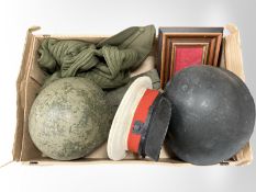 A box of military clothing, caps, helmets etc.
