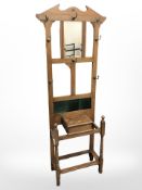 An Edwardian oak tiled back hall stand, 71cm x 27cm x 183cm.