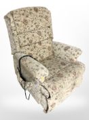 An electric reclining armchair in floral upholstery