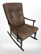 A late 20th century Danish wooden framed stitched brown leather rocking chair,