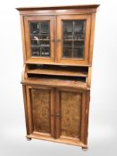 An early 20th century continental glazed walnut double door cabinet, 76cm x 54cm x 149cm.