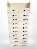 An early 20th century painted pine twenty drawer chest,