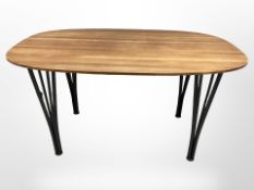 A contemporary Danish oval teak dining table on tapering metal legs,