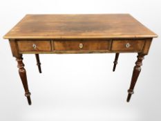 A 19th-century walnut three-drawer table, 115cm wide x 62cm deep x 78cm high.