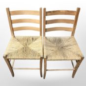 A set of four pine and rattan ladder back chairs.