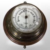 A circular oak and brass ship's barometer,