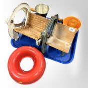 Two early-20th century Danish Raadvad cast-iron rye bread slicers, a further enamelled wall pocket,