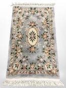 A Chinese floral rug, 175cm x 97cm.