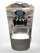 A commercial stainless steel slushie maker, on casters, height 130cm.