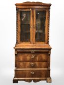 A 19th century continental burr walnut glazed double door bookcase, fitted drawers beneath,