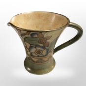 A Charlotte Rhead Bursley ware milk jug with tube lined floral decoration, height 9.5cm.