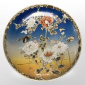 An early 20th-century Japanese earthenware charger depicting a bird amongst foliage, diameter 36cm.