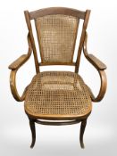 A beech and bergere armchair.