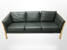 A late 20th century Danish dark green stitched leather wooden framed three seater settee,