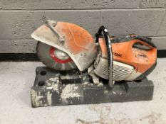 A Stihl petrol concrete saw and fence base