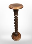 A reproduction mahogany barley twist torchere,