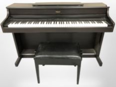 A Roland HP337e digital piano with stool and lead (continental wiring),