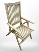 A folding teak garden armchair.
