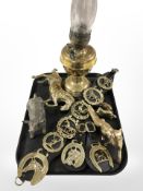 A brass oil lamp, a quantity of horse brasses, animal figures, etc.