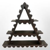 A Scandinavian stained pine triangular wall shelf, width 78cm.