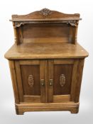 An early 20th century continental carved oak double door side board, 89cm x 50cm x 120cm.