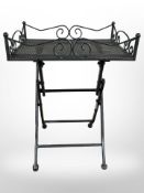 A modern cast metal folding table,