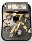 A group of gent's wristwatches and a watch display case.