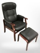 A contemporary stained beech black leather armchair and matching footstool,