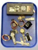 A group of gent's wristwatches and a watch display case.