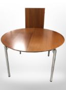 A contemporary Danish teak veneered circular dining table on chrome legs, diameter 120cm.