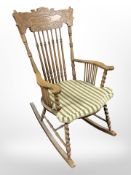 A carved beech spindle back rocking chair