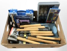 A group of carpentry chisels, case of screwdrivers, nuts and bolts and other hardware.