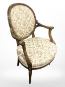 A continental carved beech salon armchair in floral upholstery
